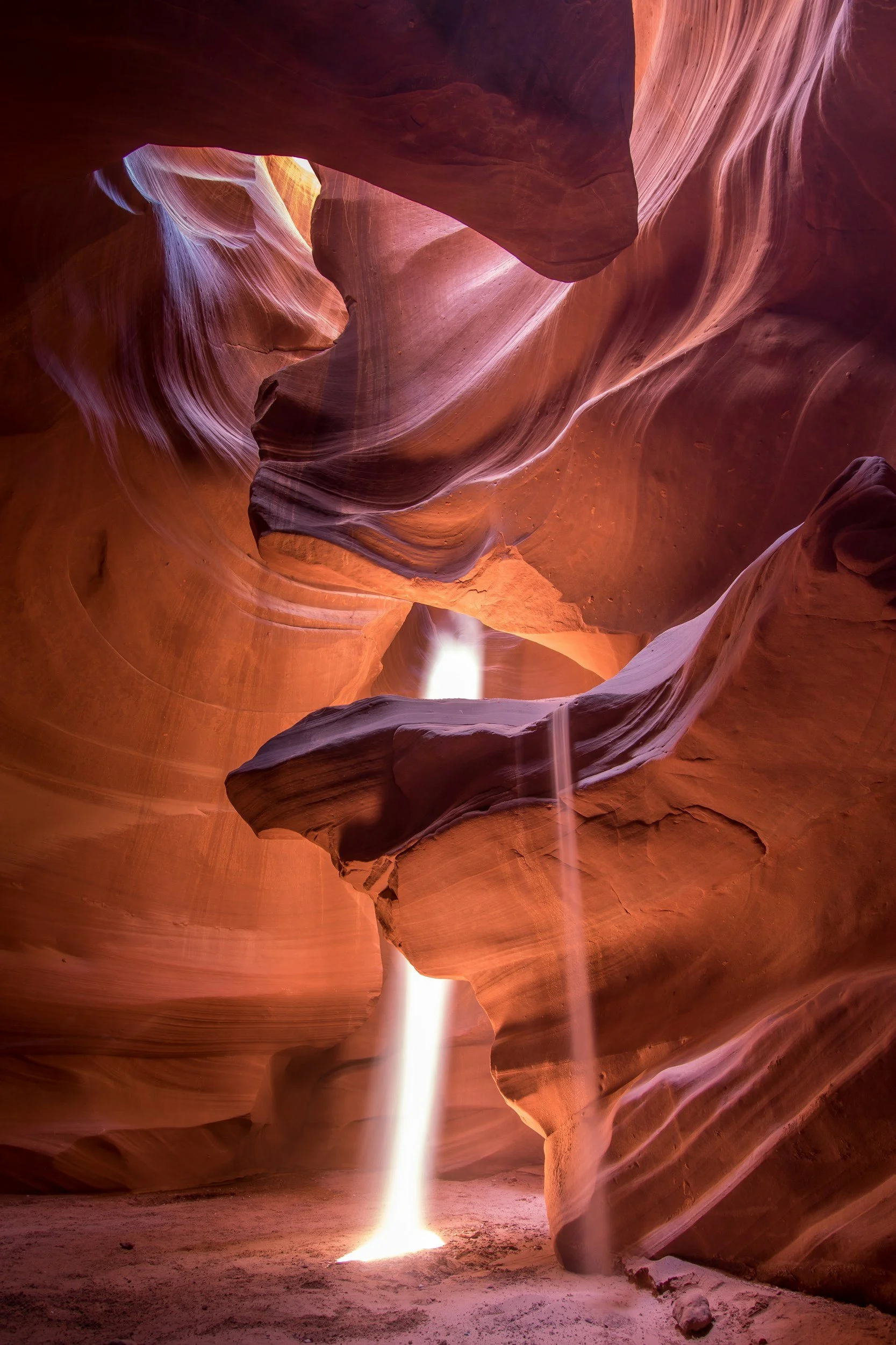 Sunlight entering a sculptural sandstone canyon.