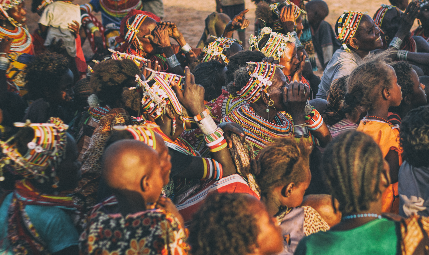 A large cultural gathering in colourful traditional garments.