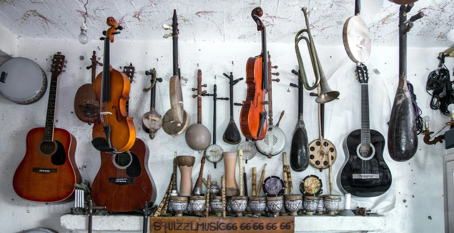 A collection of stringed and percussion instruments.