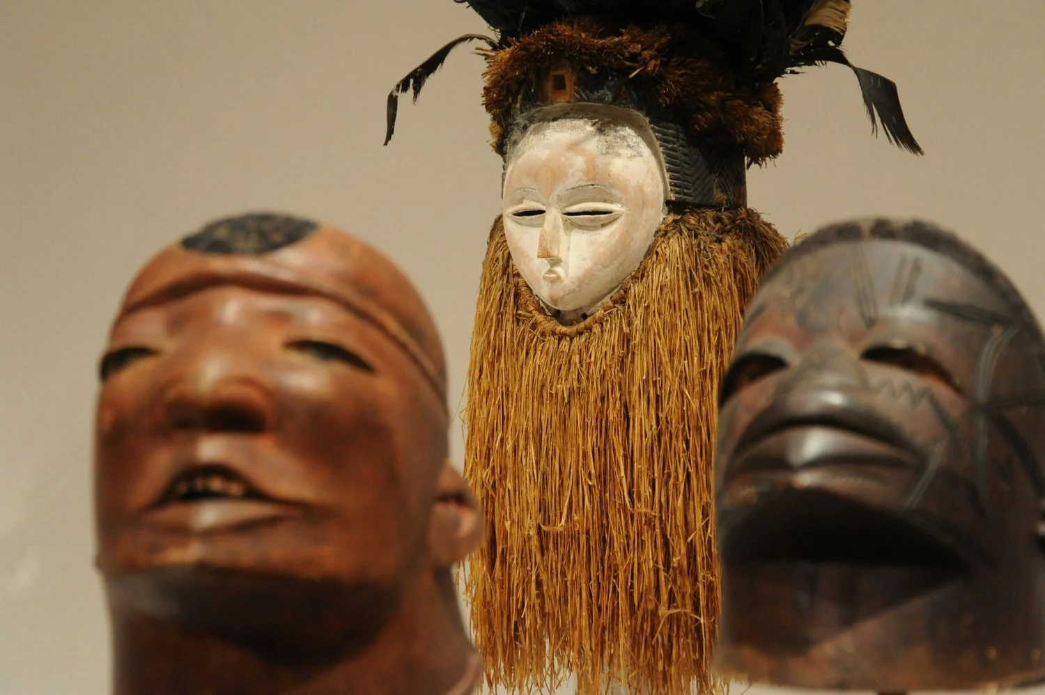 A group of sculptural African masks and figures.